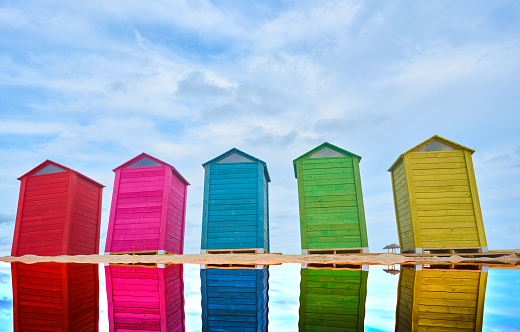A Colorful beach huts with cloudy sky. Copy space