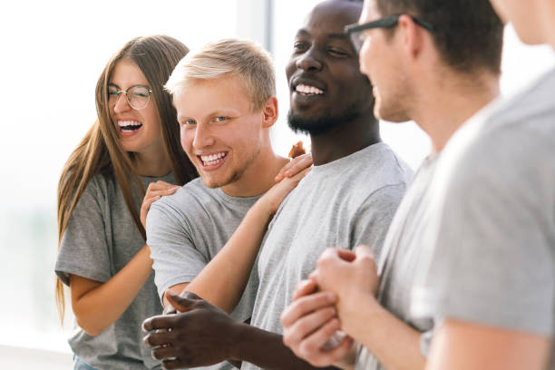 istock group of happy young people standing in a bright room 1277644871