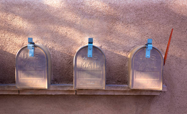 istock Line of Three Classic Old Rural US Mailboxes, Adobe Wall 1277647867