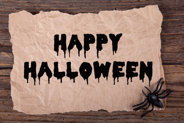 istock Halloween greeting card on rustic paper and wooden table 1277648166