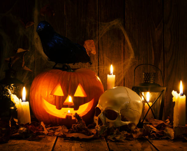 istock Halloween Jack-o-Lantern Pumpkins on rustic wooden background 1277650168