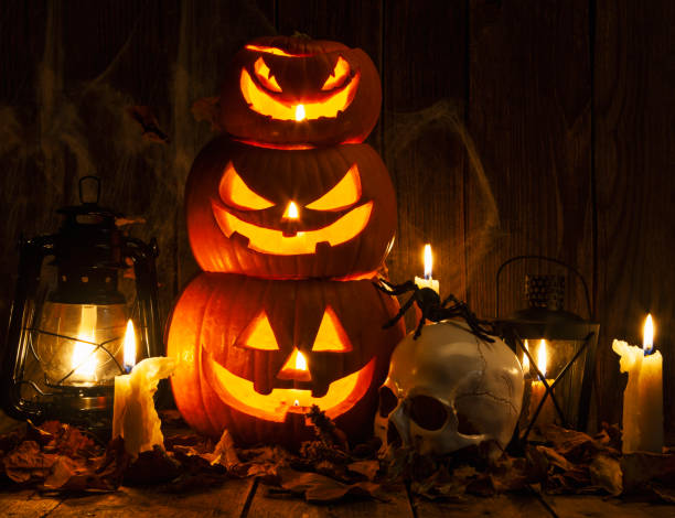 istock Halloween Jack-o-Lantern Pumpkins on rustic wooden background 1277650218