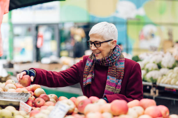 istock Older woman touching the apple 1277658580