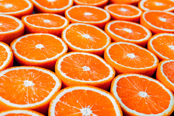 istock Red oranges or grapefruits are cut in half on black background. 1277658993