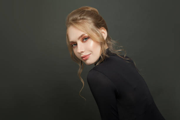 istock Attractive fashion model on black background, portrait 1277665447