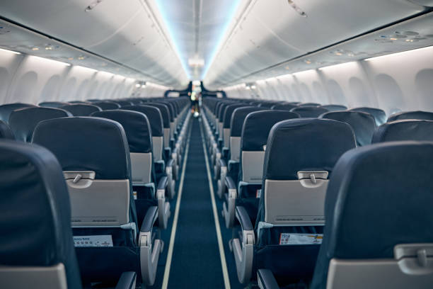 istock Airline passenger chairs and aisle in airplane cabin 1277665841