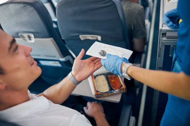 istock Passenger eating food on board the commercial plane 1277665863