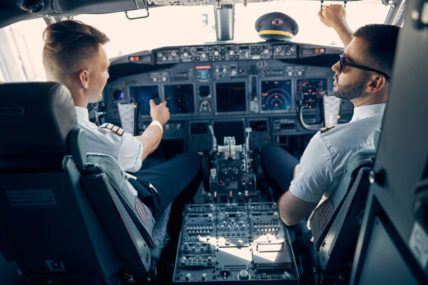 istock Two handsome man sitting on the chair in cockpit 1277665876