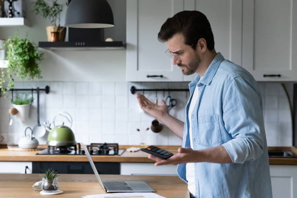 Frustrated man confused by financial error making payment