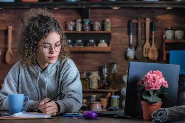 istock Hispanic curly hair young woman using laptop working at home office 1277669427
