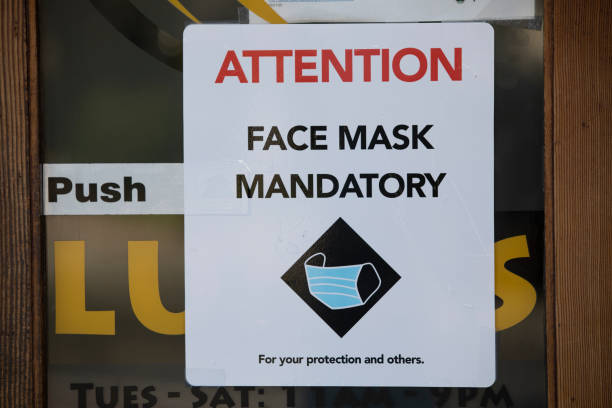 Face Mask Mandate San Gabriel, California / USA - July 11, 2020: A business displays a mandatory face mask sign in response to the COVID-19 pandemic. mandate stock pictures, royalty-free photos & images