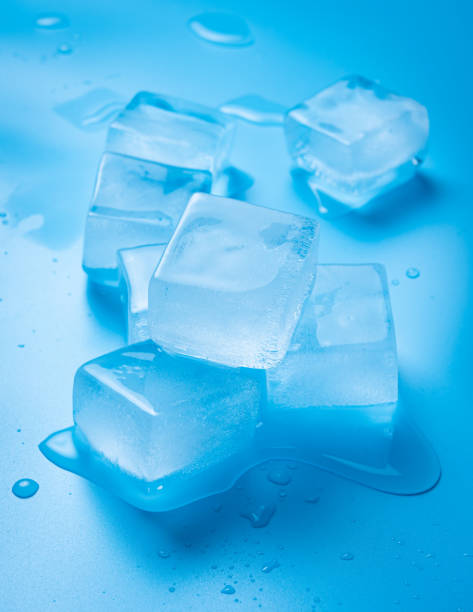 Ice cubes with water drops on a blue background