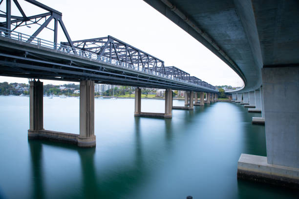 istock Old iron bridge and new concrete bridge side by side on Sydney harbour Australia 1277676657