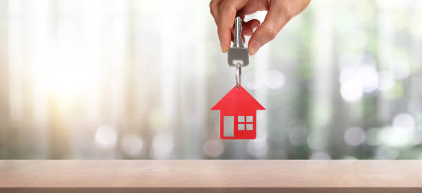 istock Real estate agent handing over house keys 1277680323