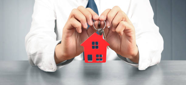 istock Real estate agent handing over house keys 1277680329