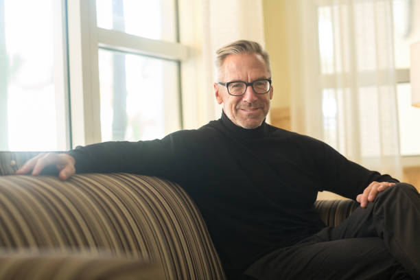 istock Portarit of a handsome older man sitting on a sofa 1277692392