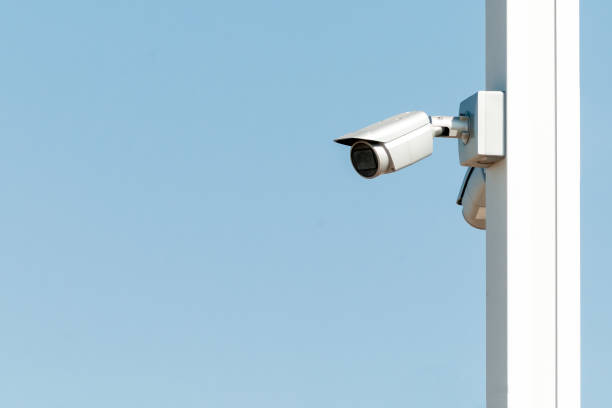 istock Security camera on the blue wall in summer day 1277696762