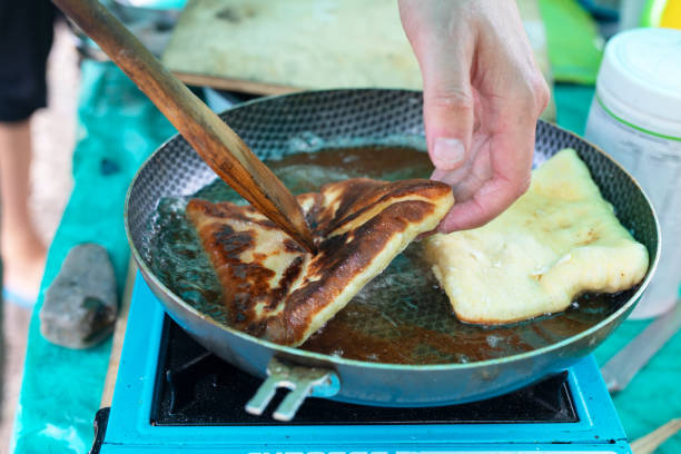 istock Cooking pies on outdoors. khachapuri or belyash fried in a pan 1277702825