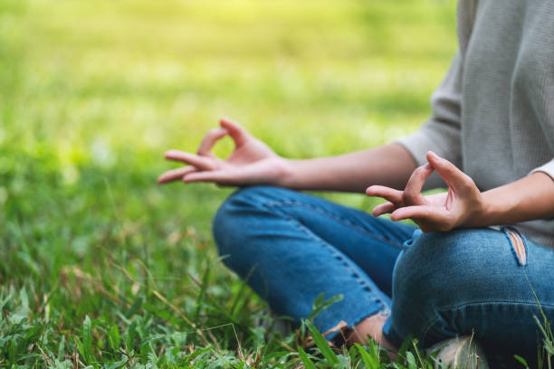 istock a woman meditating in nature 1277704029