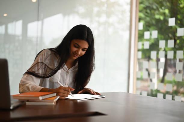 istock Female graphic designer using stylus pen drawing on blank screen tablet in modern office. 1277705081