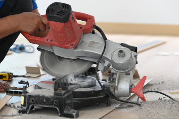 istock Skilled carpenter cutting a piece of wood in his woodwork workshop using a circular saw on wooden table. 1277705247