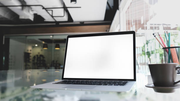 istock Office desk with blank screen laptop, pencils, coffee cup and on white desk. 1277705692