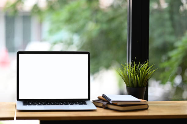 istock Copy space computer laptop and books, minimal stuff on wooden desk. 1277705751
