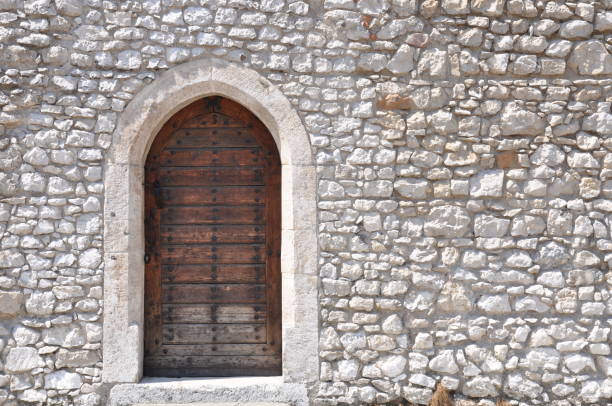 istock Ancient wooden door and stone wall 1277708105