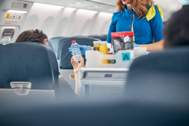 istock Air stewardess serving snacks from the drinks trolley 1277718735