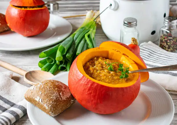 Pumpkin soup served in a hollowed out pumpkin - ready to eat