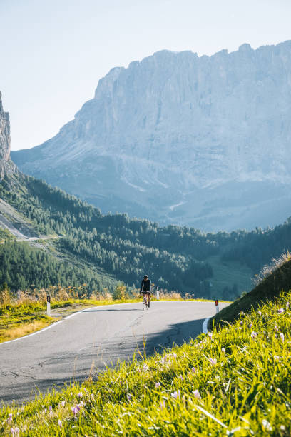 istock Road biker ascends mountain road in the morning 1277726593