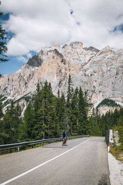 istock Road biker ascends mountain road in the morning 1277726705