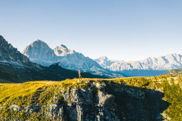 istock Hiker walks along mountain ridge at sunrise 1277726855