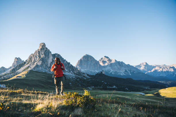 istock Hiker walks along mountain ridge at sunrise 1277727067