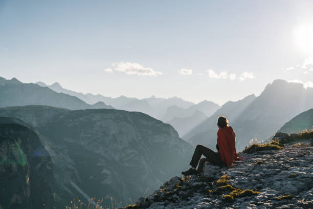 istock Hiker relaxes on mountain ridge at sunrise 1277728331