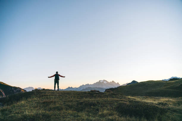 istock Hiker traverses alpine meadow at sunrise 1277728432