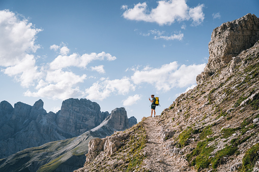 He takes photo of Dolomites in the distance