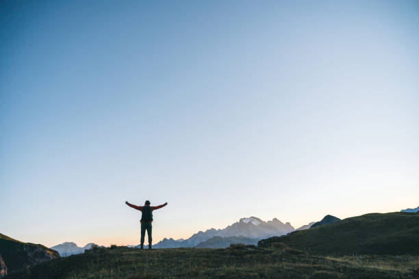 istock Hiker traverses alpine meadow at sunrise 1277728738
