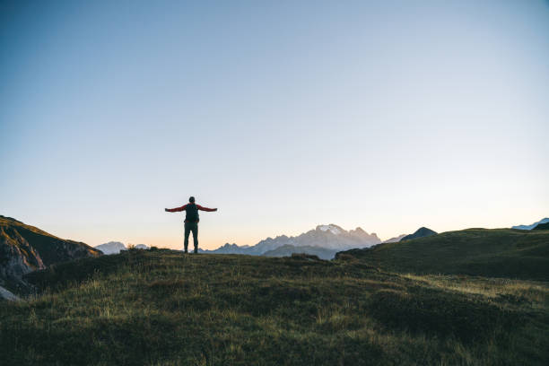 istock Hiker traverses alpine meadow at sunrise 1277728776