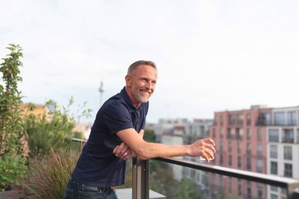 istock relaxed bearded midaged man standing on balcony in Berlin 1277733235