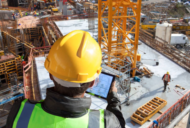 engineer architect construction worker on construction site with tablet computer - fotografia de stock