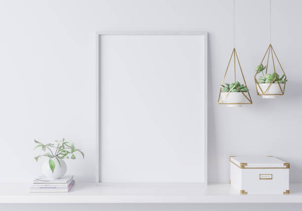 White mock up frame in modern interior, close up for white box and plants on shelf, minimal design. Stock photo