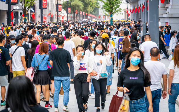 crowd of people wearing surgical face mask on the 2020 china national day and first day of golden week holidays in jianghan pedestrian road in wuhan hubei china - china covid imagens e fotografias de stock