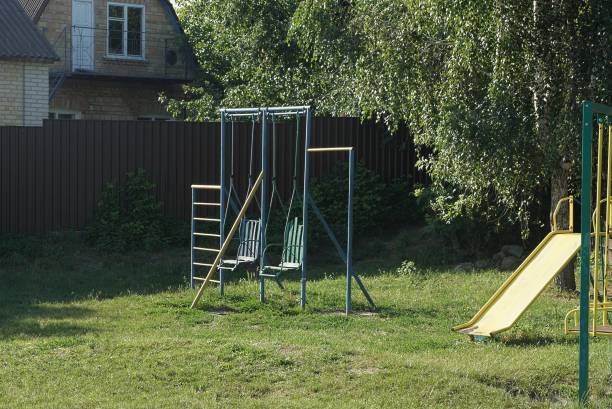 istock two blue iron swings on a playground 1277741149