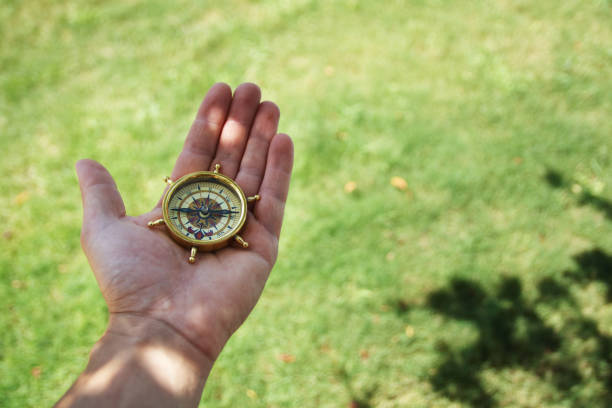istock Man hold compass in nature background for journey trip 1277741172
