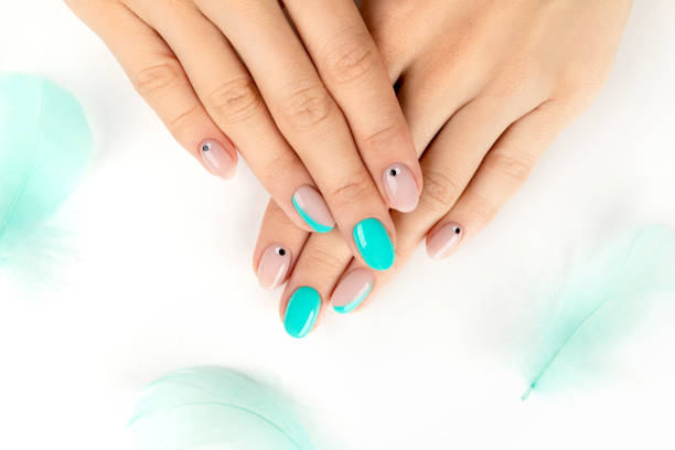 istock Well-groomed female hands with a bright modern design on white 1277741264