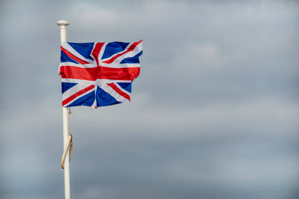 istock British flag flag fluttering in strong wind against cloudy background 1277741270