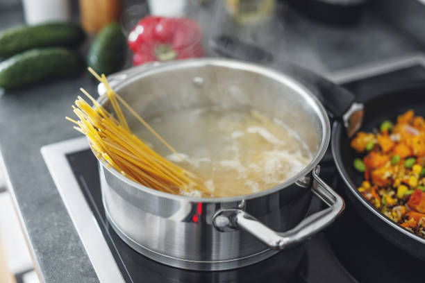 istock Boiling pot with cooking spaghetti pasta in the kitchen. Closeup 1277741476