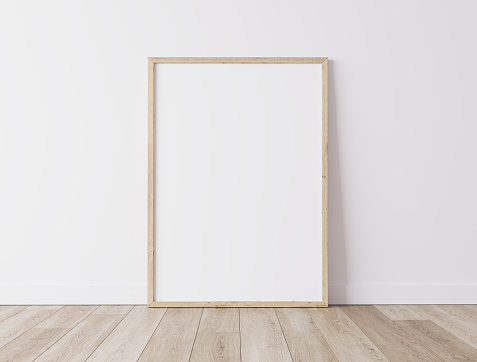 Vertical wooden frame Standing on parquet floor with white background, minimal frame mock up interior