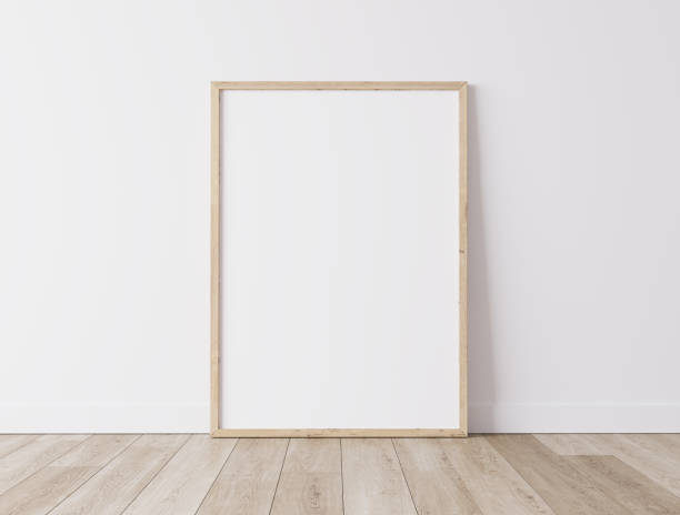 Vertical wooden frame Standing on parquet floor with white background, minimal frame mock up interior stock photo